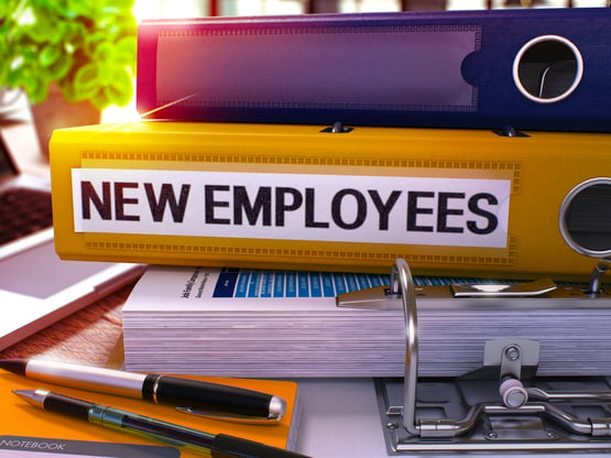 Yellow Office Folder with Inscription New Employees on Office Desktop with Office Supplies and Modern Laptop. New Employees Business Concept on Blurred Background. New Employees - Toned Image. 3D.